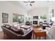Spacious living room with hardwood floors, fireplace, and sliding glass doors to sunroom at 2417 Se 23Rd St, Ocala, FL 34471