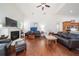Living room with vaulted ceiling, fireplace, hardwood floors, and a view into the kitchen at 2417 Se 23Rd St, Ocala, FL 34471