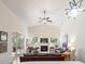 Well-lit living room boasts a fireplace, ceiling fan, and sliding door access to the lanai at 2417 Se 23Rd St, Ocala, FL 34471