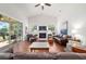 Cozy living room featuring a fireplace, hardwood floors, and sliding glass doors to sunroom at 2417 Se 23Rd St, Ocala, FL 34471