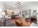 Spacious living room with hardwood floors, ceiling fan, and sliding door to the screened patio at 2417 Se 23Rd St, Ocala, FL 34471