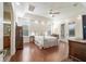Large main bedroom featuring tray ceiling, ceiling fan, and ensuite bath at 2417 Se 23Rd St, Ocala, FL 34471