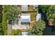 An aerial shows the property with a metal roof, gravel parking, and boat access to the channel at 24628 Fox Rd, Astor, FL 32102