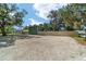 Spacious gravel yard, two-story home, and ample parking at 24628 Fox Rd, Astor, FL 32102