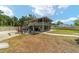 Spacious backyard with a screened-in porch, swing set, and outdoor seating, perfect for relaxing and entertaining at 24628 Fox Rd, Astor, FL 32102