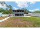 A two-story house with a screened porch and spacious backyard, excellent for outdoor living and entertaining at 24628 Fox Rd, Astor, FL 32102
