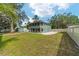 A two-story house with a screened porch and spacious backyard, excellent for outdoor living and entertaining at 24628 Fox Rd, Astor, FL 32102