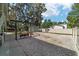 Shaded backyard with swing set, gravel, and privacy fence at 24628 Fox Rd, Astor, FL 32102