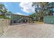 Two-story home with a swing set, gravel yard, and outdoor staircase at 24628 Fox Rd, Astor, FL 32102