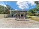 Outdoor grill, seating area, and hammock in the backyard at 24628 Fox Rd, Astor, FL 32102