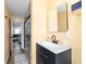 View into a bathroom that features a tiled shower, single sink vanity, and a mirror above the sink at 24628 Fox Rd, Astor, FL 32102
