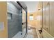 Modern bathroom with a tiled walk-in shower with glass door and an adjacent toilet at 24628 Fox Rd, Astor, FL 32102