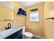 Bathroom featuring a toilet, sink with black hardware and faucet, and alligator wall decor at 24628 Fox Rd, Astor, FL 32102