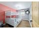Cozy bedroom featuring a white bunk bed, ceiling fan, mini-split AC, and a wall-mounted TV at 24628 Fox Rd, Astor, FL 32102