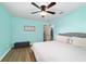 Bedroom showing two doors with an updated ceiling fan and light gray bed frame at 24628 Fox Rd, Astor, FL 32102