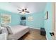 Bedroom features an updated ceiling fan, a television and two windows for natural light at 24628 Fox Rd, Astor, FL 32102