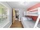 Bedroom featuring a white bunk bed, ceiling fan, wall-mounted TV, and a window with blinds at 24628 Fox Rd, Astor, FL 32102