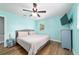 Bedroom featuring aqua walls, ceiling fan and light gray bed frame at 24628 Fox Rd, Astor, FL 32102
