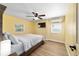Bedroom with a bed, a ceiling fan, a wall-mounted TV, and a window at 24628 Fox Rd, Astor, FL 32102