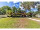 Waterfront property featuring a wooden dock with ample seating, perfect for enjoying the waterfront view at 24628 Fox Rd, Astor, FL 32102