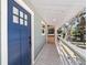Inviting entrance with a blue front door, wooden walkway, and picturesque views of the river at 24628 Fox Rd, Astor, FL 32102
