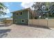Two-story home, gravel yard, and fenced property line at 24628 Fox Rd, Astor, FL 32102