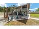 Back exterior view of a home featuring a patio with seating, grill and staircase at 24628 Fox Rd, Astor, FL 32102