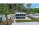 Exterior of home featuring a screened-in porch and fenced yard with outdoor seating at 24628 Fox Rd, Astor, FL 32102