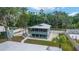 Exterior of home featuring a screened-in porch and fenced yard with outdoor seating at 24628 Fox Rd, Astor, FL 32102