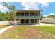 Charming two-story home featuring a screened-in porch, with lots of space for outdoor enjoyment and entertaining at 24628 Fox Rd, Astor, FL 32102