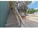 Exterior stairs lead to a charming swing set surrounded by a white gravel and fenced yard at 24628 Fox Rd, Astor, FL 32102