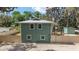 Exterior home view features horizontal siding, a metal roof, and a fenced-in backyard at 24628 Fox Rd, Astor, FL 32102