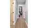 Hallway with wood-look flooring and view of bedroom with bunk beds at 24628 Fox Rd, Astor, FL 32102