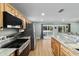 Bright kitchen features wood cabinets, granite countertops, and stainless steel appliances at 24628 Fox Rd, Astor, FL 32102