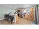 Bright kitchen with stainless steel appliances, breakfast bar, and light wood cabinetry at 24628 Fox Rd, Astor, FL 32102