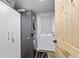 Functional laundry room features modern stacked washer and dryer, cabinet for storage, and a door to the exterior at 24628 Fox Rd, Astor, FL 32102