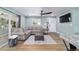 Inviting living room with a comfortable sectional sofa, wood-look floors, and ample natural light at 24628 Fox Rd, Astor, FL 32102