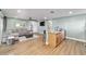 Open-concept living room with breakfast bar, neutral decor, and stylish ceiling fan at 24628 Fox Rd, Astor, FL 32102