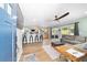 Open-concept living room with modern barstool seating, stainless steel appliances, and a comfortable seating area at 24628 Fox Rd, Astor, FL 32102