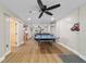 This living room has wood flooring, a ceiling fan and a ping pong table at 24628 Fox Rd, Astor, FL 32102