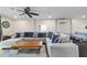 Spacious living room with a comfortable sectional sofa, a wooden coffee table, and a ceiling fan at 24628 Fox Rd, Astor, FL 32102