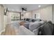 This is an open concept living room with a large sectional couch and backyard access at 24628 Fox Rd, Astor, FL 32102