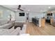 Open-concept living room featuring a breakfast bar, modern ceiling fan and neutral decor at 24628 Fox Rd, Astor, FL 32102