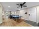 This is an open concept living room with backyard access and a ping pong table at 24628 Fox Rd, Astor, FL 32102