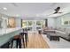 Bright living room with a comfortable sectional sofa, wood-look floors, and natural light from sliding glass doors at 24628 Fox Rd, Astor, FL 32102