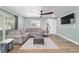 Inviting living room with a comfortable sectional sofa, wood-look floors, and ample natural light at 24628 Fox Rd, Astor, FL 32102