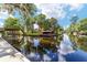 Picturesque waterfront featuring multiple docks and lush greenery, creating a tranquil and inviting atmosphere at 24628 Fox Rd, Astor, FL 32102
