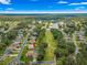 Aerial view highlighting the home's location within a lush treed community with water features at 28 Golf View Dr, Ocala, FL 34472
