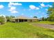 Expansive backyard featuring a well-maintained lawn and a sunroom, perfect for outdoor enjoyment at 28 Golf View Dr, Ocala, FL 34472