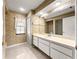 Bathroom featuring vanity, large mirror, and tiled shower at 28 Golf View Dr, Ocala, FL 34472